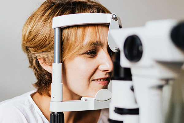 A patient having an eye examination at the slit lamp
